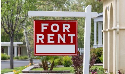 a for rent sign in front of a community